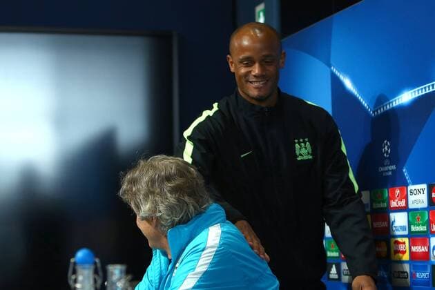 Fußball, Champions League, Manchester City Pressekonferenz Vincent Kompany pats Manuel Pellegrini, manager of Manchester City on the back during the UEFA Champions League press conference PK Pressekonferenz at the Etihad Campus. Photo credit should read: Philip Oldham Sportimage EDITORIAL USE ONLY. No use with unauthorised audio, video, data, fixture lists, club league logos or live services. Online in-match use limited to 120 images, no video emulation. No use in betting, games or single club league player publications.