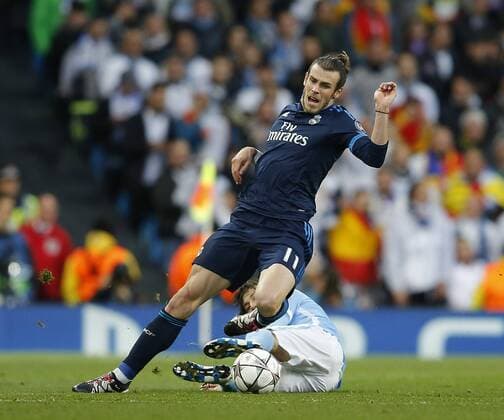 Gareth Bale of Real Madrid tackled by David Silva of Manchester City during the UEFA Champions League Semi Final match at Etihad Stadium. Photo credit should read: Simon Bellis Sportimage EDITORIAL USE ONLY. No use with unauthorised audio, video, data, fixture lists, club league logos or live services. Online in-match use limited to 120 images, no video emulation. No use in betting, games or single club league player publications.