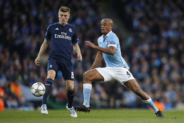 Toni Kroos of Real Madrid and Vincent Kompany of Manchester City during the UEFA Champions League Semi Final 1st leg match at the Etihad Stadium. Photo credit should read: Philip Oldham Sportimage EDITORIAL USE ONLY. No use with unauthorised audio, video, data, fixture lists, club league logos or live services. Online in-match use limited to 120 images, no video emulation. No use in betting, games or single club league player publications.