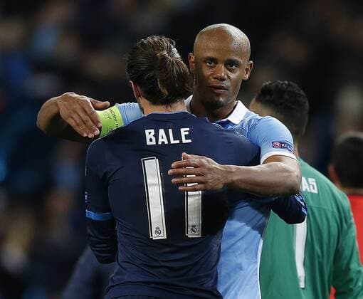Vincent Kompany of Manchester City hugs Gareth Bale of Real Madrid at the end of the match during the UEFA Champions League Semi Final match at Etihad Stadium. Photo credit should read: Simon Bellis Sportimage EDITORIAL USE ONLY. No use with unauthorised audio, video, data, fixture lists, club league logos or live services. Online in-match use limited to 120 images, no video emulation. No use in betting, games or single club league player publications.