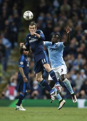 Gareth Bale of Real Madrid and Bacary Sagna of Manchester City during the UEFA Champions League Semi Final 1st leg match at the Etihad Stadium. Photo credit should read: Philip Oldham Sportimage EDITORIAL USE ONLY. No use with unauthorised audio, video, data, fixture lists, club league logos or live services. Online in-match use limited to 120 images, no video emulation. No use in betting, games or single club league player publications.
