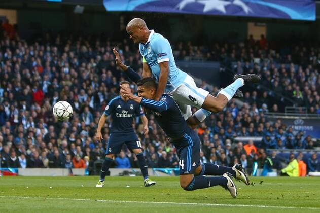 Vincent Kompany of Manchester City wins a header over Casemiro of Real Madrid during the UEFA Champions League Semi Final 1st leg match at the Etihad Stadium. Photo credit should read: Philip Oldham Sportimage EDITORIAL USE ONLY. No use with unauthorised audio, video, data, fixture lists, club league logos or live services. Online in-match use limited to 120 images, no video emulation. No use in betting, games or single club league player publications.