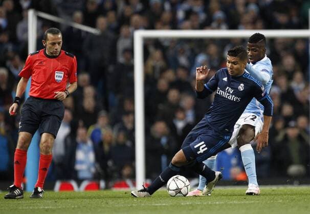 26.04.2016. The Etihad, Manchester, England. UEFA Champions League. Manchester City versus Real Madrid. Referee Cuneyt Cakir looks on asReal Madrid midfielder Casemiro turns past Manchester City striker Kelechi Iheanacho xAlanxMartinx  ActionPlus11731116