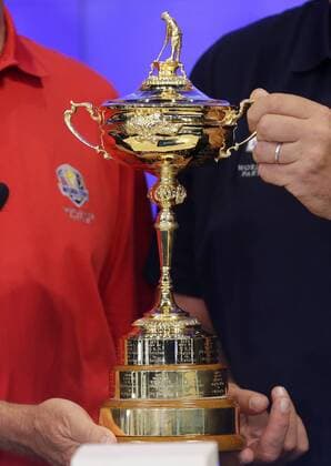 Ryder Cup Captains Davis Love III and Darren Clarke hold the The Ryder Cup trophy when they ring the opening bell at the Nasdaq in Times Square in New York City on April 28, 2016.  NYP20160428109 JOHNxANGELILLO