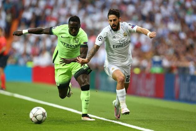 Bacary Sagna of Manchester City battles Isco of Real Madrid during the UEFA Champions League Semi Final 2nd leg match at the Santiago Bernabeu stadium. Photo credit should read: Philip Oldham Sportimage EDITORIAL USE ONLY. No use with unauthorised audio, video, data, fixture lists, club league logos or live services. Online in-match use limited to 120 images, no video emulation. No use in betting, games or single club league player publications.