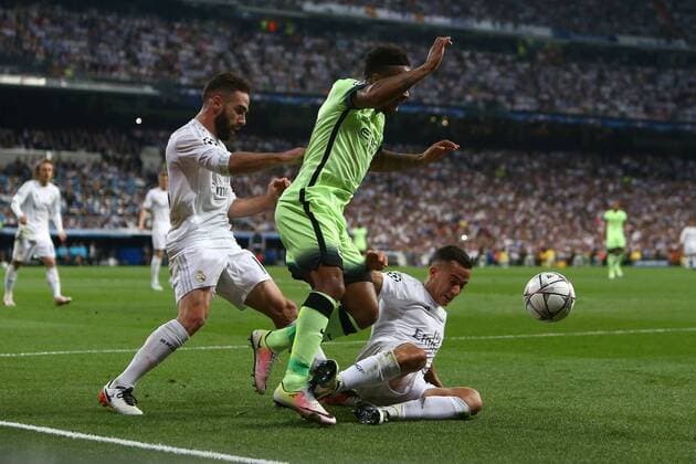 Fußball, CL, Real Madrid - Manchester City Lucas Vazquez of Real Madrid tackles Raheem Sterling of Manchester City during the UEFA Champions League Semi Final 2nd leg match at the Santiago Bernabeu stadium. Photo credit should read: Philip Oldham Sportimage EDITORIAL USE ONLY. No use with unauthorised audio, video, data, fixture lists, club league logos or live services. Online in-match use limited to 120 images, no video emulation. No use in betting, games or single club league player publications.