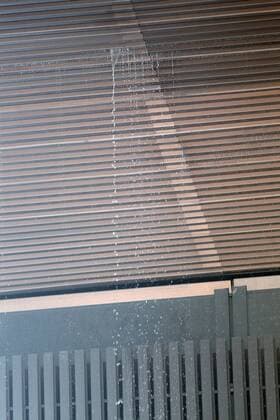 A cascade of water seeps through the roof of the Principal Court on the Caja Magica (Magic Box) during Madrid Open Tennis 2016 match.May, 6, 2016.  (20160506140)