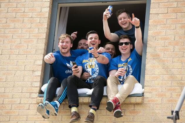 May 7, 2016 - Leicester, Leicestershire, UK - Leicester, UK. Leicester City fans celebrating outside the King Power stadium before their match with Everton before lifting the Premiership trophy. Pictured, lads in an over looking hotel, egg on the crowd chants. Leicester City Premier League Coronation  - ZUMAl94_
