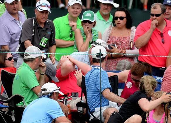May 8, 2016 - Charlotte, NC, USA - A fan is hit in the face with a ball driven by golfer Roberto Castro to the 18th green during the Wells Fargo Championship on Sunday, May 8, 2016, at Quail Hollow Club in Charlotte, N.C. Wells Fargo Championship - ZUMAm67_