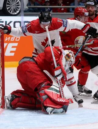 ST. PETERSBURG, RUSSIA. MAY 9, 2016. Belarus goalie Kevin Lalande (front) defends against Canada s Brendan Gallagher in their 2016 IIHF World Championship WM Weltmeisterschaft Preliminary Round Group B Ice hockey Eishockey match at the Yubileyny Sports Palace. Alexander Demianchuk TASS  TS02237A