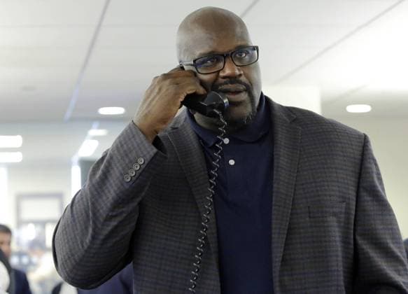 Shaquille O Neal speaks to a client at the 2016 BTIG Commissions for Charity Day in New York City on May 10, 2016.  NYP20160510116 JOHNxANGELILLO