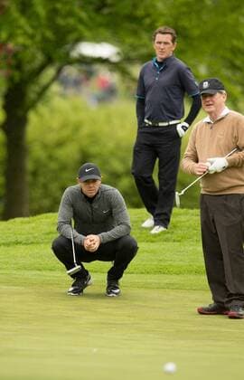 17.05.2016. The K Club, Straffan, Co. Kildare, Ireland. Dubai Duty Free Irish Open Golf Championship Pro-AM. Rory Mcilroy lines up his putt on the 1st green as AP McCoy and JP McManus look on. xPeterxFitzpatrickx  ActionPlus11738368