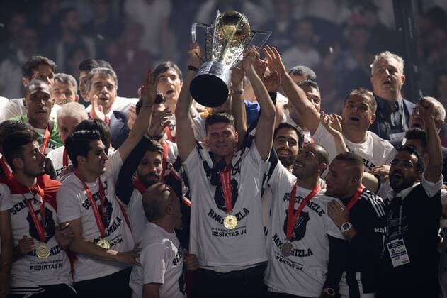 Besiktas s Players Mario Gomez hold the Turkish Super League soccer championship trophy during a celebration at Vodafone Arena in Istanbul May 19, 2016 
