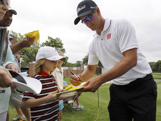May 25, 2016 - Fort Worth, TX, USA - On the 16th green, 2014 tournament winner Adam Scott signs a flag for Alex Wimmiams during the Colonial Pro-Am at the Dean & Deluca Invitational on Wednesday, May 25, 2016, in Fort Worth, Texas. Dean & Deluca Invitational Pro-Am - ZUMAm67_