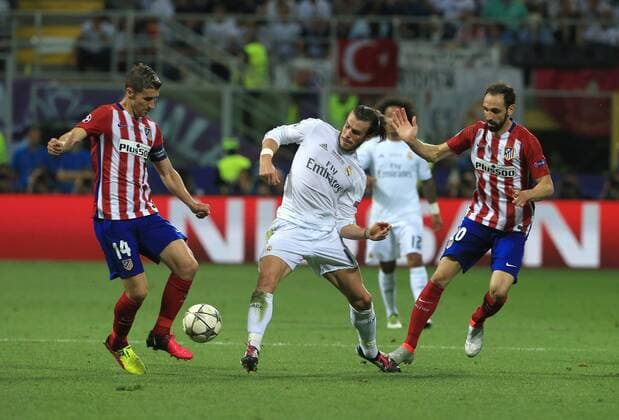Gareth Bale of real Madrid tussles with Gabi and Juanfran of Atletico Madrid during the UEFA Champions League Final match at the Giuseppe Meazza Stadium, Milan, Italy. Photo credit should read: David Klein Sportimage EDITORIAL USE ONLY. No use with unauthorised audio, video, data, fixture lists, club league logos or live services. Online in-match use limited to 120 images, no video emulation. No use in betting, games or single club league player publications.