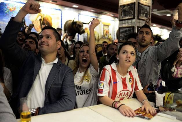 May 28, 2016 - Madrid, Spain - Fans of Atletico and Real Madrid react in the center of the Madrid, Spain, on May 28, 2016 during the final of the UEFA Champions League at Stadio Giuseppe Meazza on May 28, 2016 in Milan, Italy. Atletico And Real Fans Watch The Champions League Final In Madrid  - ZUMAn230