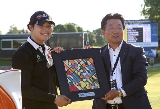 May 29, 2016 - Ann Arbor, Michigan, United States - Ariya Jutanugarn of Bangkok, and Kyung Ahn Moon, Chairman of Volvik INC pose for a photo after winning the final round of the inaugural LPGA Golf Damen Volvik Championship at Travis Pointe Country Club in Ann Arbor, MI, USA Sunday, May 29, 2016. LPGA Volvik Championship - Final Round  - ZUMAn230
