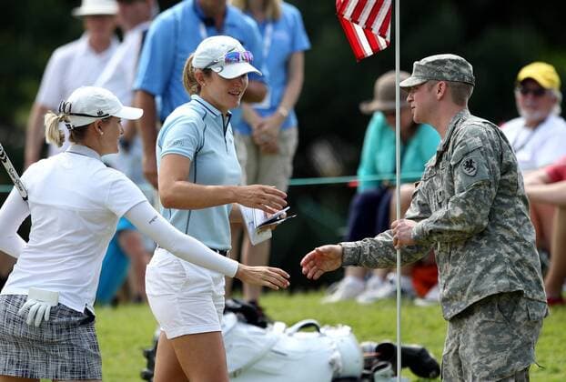 May 29, 2016 - Ann Arbor, Michigan, United States - U.S.Army Specialist Zachary Loughrige greets Celine Herbin of France , left, and Sarah Jane Smith, center, of Caloundra, Queensland at the ninth green where he was tending the American flag during the final round of the inaugural LPGA Golf Damen Volvik Championship over Memorial Weekend at Travis Pointe Country Club in Ann Arbor, MI, USA Sunday, May 29, 2016. LPGA Volvik Championship - Final Round - ZUMAn230
