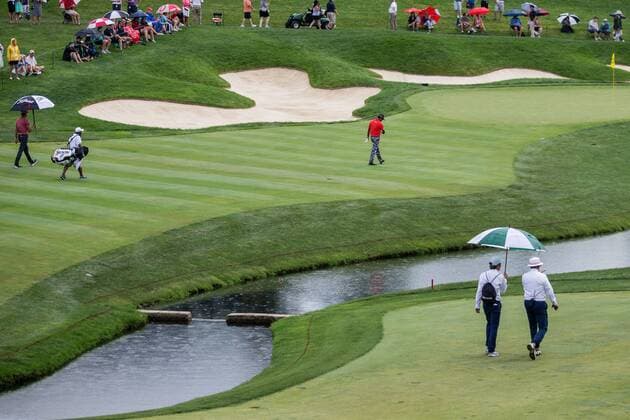 June 4, 2016 - Dublin, Ohio, U.S - Rafa Cabrera Bello and Anirban Lahiri approach the 14th green in the rain during the third round of The Memorial Tournament at Muirfield Village Golf Club, Dublin, Ohio. Golf 2016 - The Memorial Tournament - Third Round - ZUMAs304