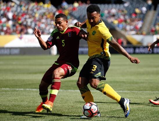 Venezuela midfielder Arquimedes Figuera (L) and Jamaica defender Michael Hector go for the ball during the first half of a 2016 Copa America Centenario Group C match at Soldier Field in Chicago on June 5, 2016.  CHI2016060506 BRIANxKERSEY