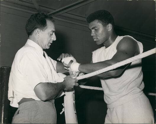 June 3, 2016 - File - MUHAMMAD ALI, the three time heavyweight boxing champion, has died at the age of 74. He had been fighting a respiratory illness. The Greatest was the dominant heavyweight boxer of the 1960s and 1970s, Ali won an Olympic gold medal in Rome in 1960, captured the professional world heavyweight championship on three separate occasions, and successfully defended his title 19 times. PICTURED: May 05, 1966 - CASSIUS CLAY Trains For Cooper Fight: World Heavyweight champion, Cassius Clay, (Muhammad Ali), was today training at the Territorial Army Gymnasium, White City, for his fight against British champion, Henry Cooper at Arsenal Stadium, London, on May 21. Photo shows Cassius Clay has his hands bandaged by manager ANGELO DUNDEE - prior to today s training session. Ali : The Greatest Of All Time 1942 - 2016 - ZUMAk09_