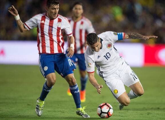 PASADENA, June 7, 2016 -- Colombia s James Rodriguez (R) falls during the Copa America Centenario Group A match between Colombia and Paraguay at Rose Bowl Stadium in Pasadena, California, the United States, June 7, 2016. ) (SP)U.S.-PASADENA-COPA AMERICA-GROUP A-COL VS PAR YangxLei 