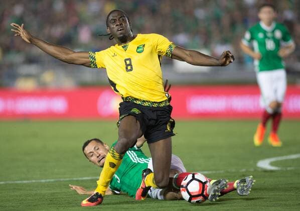 Jamaica s Clayton Donaldson (Top) is tackled during the Copa America Centenario tournament Group C football match between Mexico and Jamaica in Pasadena, California, the United States, on June 9, 2016. ) (SP)U.S.-PASADENA-COPA AMERICA-GROUP C-MEX VS JAM YangxLei 