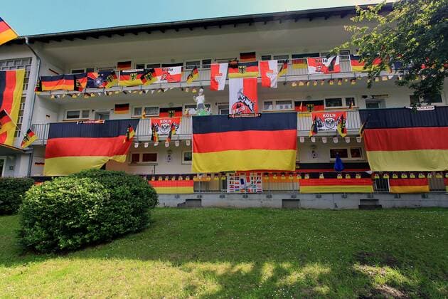 Deutschland-Fahnen hängen an anläßlich der Fußball-EM 2016 in Frankreich an einer Hausfassade in Köln. Fahnen zur Fußball-EM