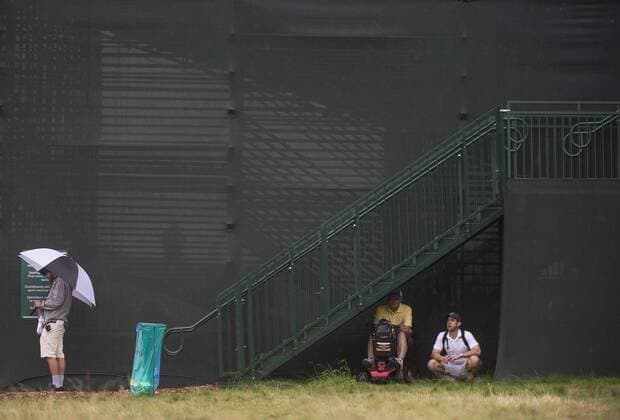 Golf, US Open Patrons seek shelter under a grandstand during a rain delay in the first round of the 2016 U.S. Open at Oakmont Country Club in Oakmont, Pennsylvania on June 15, 2016.  OAK20160616304 KEVINxDIETSCH