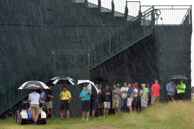 Patrons seek shelter under a grandstand during a rain delay in the first round of the 2016 U.S. Open at Oakmont Country Club in Oakmont, Pennsylvania on June 15, 2016.  OAK20160616307 KEVINxDIETSCH
