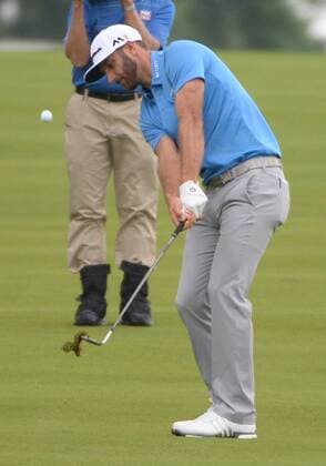 Dustin Johnson chips up to save par on the first hole of his first round during the Friday round of the U.S. Open golf championship at Oakmont Country Club near Pittsburgh, Pennsylvania on June 17, 2016. Johnson was just starting his first round due to the rain delays yesterday and will play his second 18 later today.  OAK20160617110 PATxBENIC