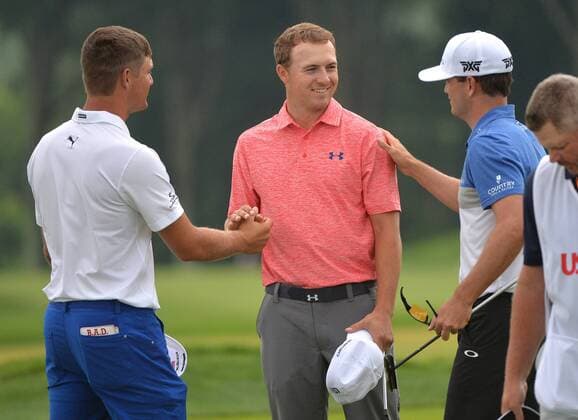 Jordan Spieth (C) shakes hands with Bryson DeChambeau (L) and Zach Johnson as they finish up their first round at the 2016 U.S. Open at Oakmont Country Club in Oakmont, Pennsylvania on June 17, 2016.  OAK20160617308 KEVINxDIETSCH