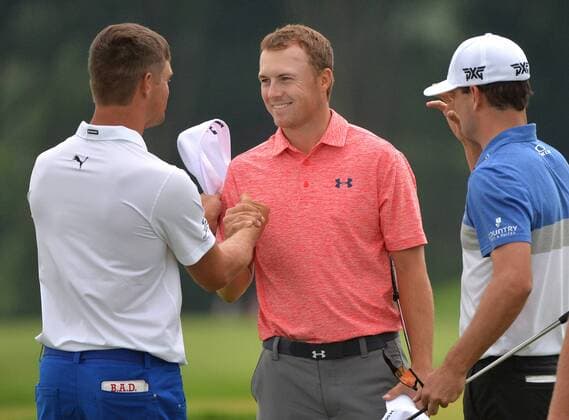 Jordan Spieth (C) shakes hands with Bryson DeChambeau (L) and Zach Johnson as they finish up their first round at the 2016 U.S. Open at Oakmont Country Club in Oakmont, Pennsylvania on June 17, 2016.  OAK20160617309 KEVINxDIETSCH