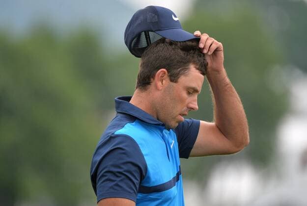 Charles Schwartzel of South Africa adjusts his hat as he walks off the 10th tee at the 2016 U.S. Open at Oakmont Country Club in Oakmont, Pennsylvania on June 17, 2016.  OAK20160617305 KEVINxDIETSCH