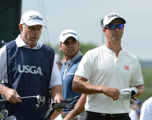 Australians Adam Scott (R) and Jason Day (C) take a look at the third hole of their first round during the second day of the U.S. Open golf championship at Oakmont Country Club near Pittsburgh, Pennsylvania on June 17, 2016. They were just starting their first round due to the rain delays yesterday and will play his second 18 later today.  OAK20160617120 PATxBENIC