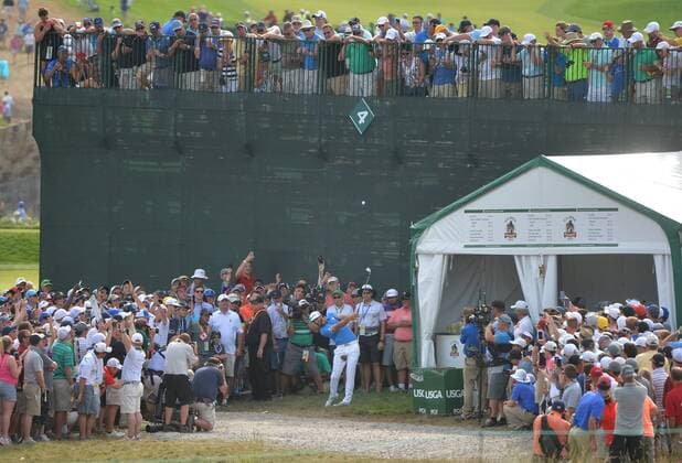 A gallery of people watch Dustin Johnson hit an iron back into play on the 2nd hole in the 3rd round at the U.S. Open at Oakmont Country Club near Pittsburgh, Pennsylvania on June 18, 2016.  OAK20160618901 KEVINxDIETSCH