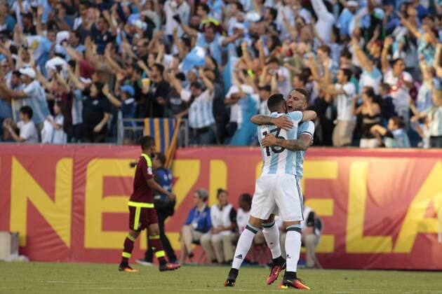 Argentina defender Nicholas Otamendi (17) gets a hug from teammate Ramior Funes Mori (13) after a goal by Gonzalo Higuain (not pictured) in the first half of the 2016 Copa America Centenario quarterfinal match against Venezuela at Gillette Stadium in Foxborough, Massachusetts on June 18, 2016.  BOS2016061805 MATTHEWxHEALEY