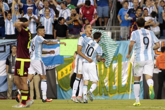 Argentina midfielder Lionel Messi (10) gives a hug to forward Eric Lamela (18) as defender Marcos Rojo (16) and forward Gonzalo Higuain (9) join the celebration after Lamela scored against Venezuela in the second half of the 2016 Copa America Centenario quarterfinal match at Gillette Stadium in Foxborough, Massachusetts on June 18, 2016. Argentina defeated Venezuela 4-1.  BOS2016061811 MATTHEWxHEALEY