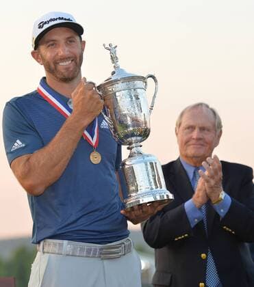 Golf Legend Jack Nicklaus applauds as Dustin Johnson holds the Championship Trophy on the 18th green after winning his first major championship in the final round at the U.S. Open at Oakmont Country Club near Pittsburgh, Pennsylvania on June 19, 2016. Johnson won with a score of 5 under par.  OAK20160619703 KEVINxDIETSCH