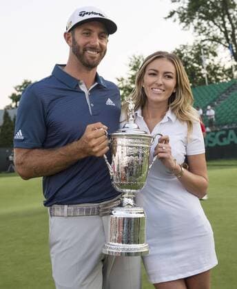 Dustin Johnson stands with Paulina Gretzky when holds the Championship Trophy on the 18th green after winning his first major championship in the final round at the U.S. Open at Oakmont Country Club near Pittsburgh, Pennsylvania on June 19, 2016. Johnson won with a score of 5 under par.  OAK20160619752 KEVINxDIETSCH