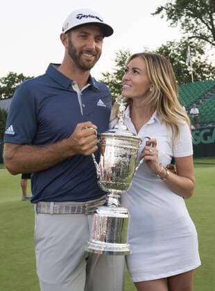 Dustin Johnson stands with Paulina Gretzky when holds the Championship Trophy on the 18th green after winning his first major championship in the final round at the U.S. Open at Oakmont Country Club near Pittsburgh, Pennsylvania on June 19, 2016. Johnson won with a score of 5 under par.  OAK20160619753 KEVINxDIETSCH