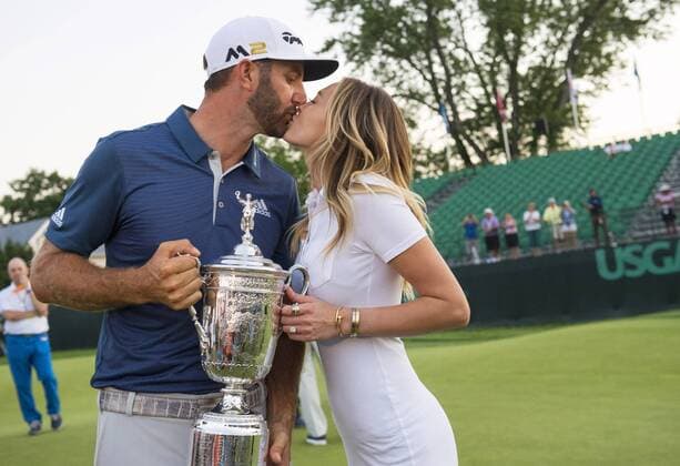Dustin Johnson kisses Paulina Gretzky when holds the Championship Trophy on the 18th green after winning his first major championship in the final round at the U.S. Open at Oakmont Country Club near Pittsburgh, Pennsylvania on June 19, 2016. Johnson won with a score of 5 under par.  OAK20160619756 KEVINxDIETSCH