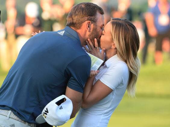Dustin Johnson celebrates by kissing Paulina Gretzky on the 18th green after making a birdie putt and winning his first major championship in the final round at the U.S. Open at Oakmont Country Club near Pittsburgh, Pennsylvania on June 19, 2016. Johnson won with a score of 5 under par.  OAK20160619870 PATxBENIC