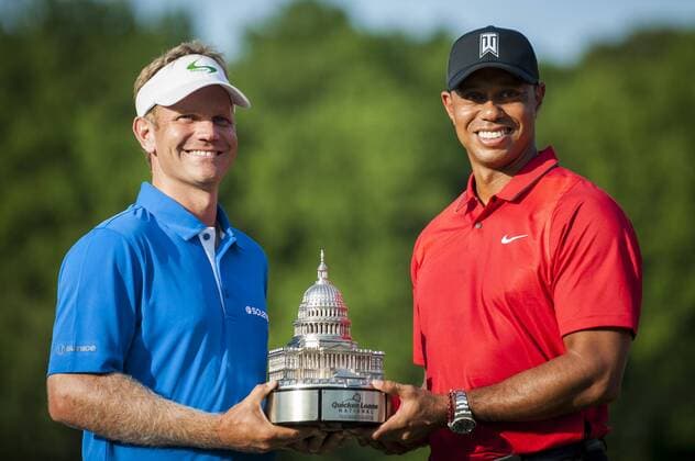 Billy Hurley III, of Annapolis, Maryland, holds the Quicken Loans National Trophy with tournament host, Tiger Woods, following the final round of the Quicken Loans National golf tournament at Congressional CC in Bethesda, Maryland on Sunday, June 36, 2016. Hurley shot a 2-under 69 on Sunday for his first tournament win.  WAP201606261084 PETExMAROVICH