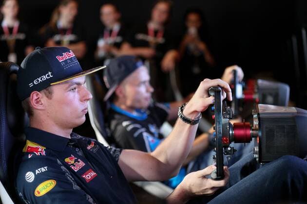 FORMULA 1 - GP of Austria 2016 SPIELBERG,AUSTRIA,30.JUN.16 - MOTORSPORTS, FORMULA 1 - Grand Prix of Austria, Red Bull Ring, preview. Image shows Max Verstappen (NED Red Bull) and Erik Lestach - hakkiJunior (SVK) playing on a simulator at Gamezone. GEPAxpictures xMaticxKlansek
