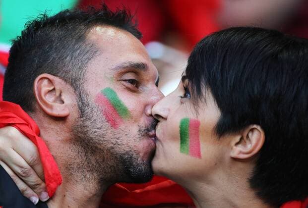 LYON, FRANCE - JULY 6, 2016: Portugal fans kiss ahead of the 2016 UEFA European Football Championship semifinal match against Wales at Stade de Lyon. Alexander Demianchuk TASS  TS0292B4