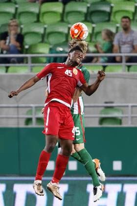 BUDAPEST, HUNGARY - JULY 20: Oliver Husing 5 of Ferencvarosi TC battles for the ball in the air with Caleb Ekuban (L) of FK Partizani during the UEFA Champions League Qualifying Round match between Ferencvarosi TC and FK Partizani at Groupama Arena on July 20, 2016 in Budapest, Hungary. LaszloxSzirtesi 
