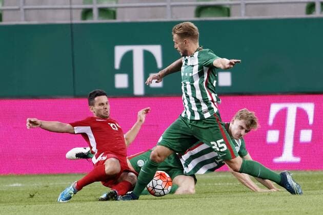 BUDAPEST, HUNGARY - JULY 20: Florian Trinks 35 of Ferencvarosi TC and Oliver Husing (R) of Ferencvarosi TC try to tackle Agustin Torassa 27 of FK Partizani during the UEFA Champions League Qualifying Round match between Ferencvarosi TC and FK Partizani at Groupama Arena on July 20, 2016 in Budapest, Hungary. LaszloxSzirtesi 