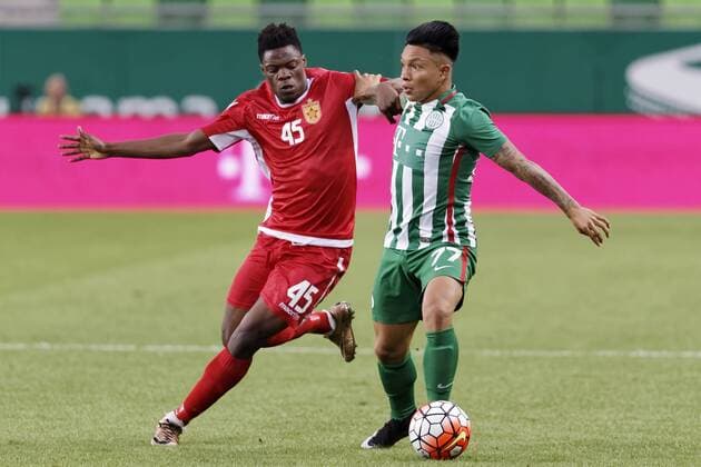 BUDAPEST, HUNGARY - JULY 20: Cristian Ramirez 77 of Ferencvarosi TC fights for the ball with Caleb Ekuban 45 of FK Partizani during the UEFA Champions League Qualifying Round match between Ferencvarosi TC and FK Partizani at Groupama Arena on July 20, 2016 in Budapest, Hungary. LaszloxSzirtesi 