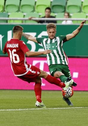 BUDAPEST, HUNGARY - JULY 20: Florian Trinks (R) of Ferencvarosi TC duels for the ball with Ylber Ramadani 16 of FK Partizani during the UEFA Champions League Qualifying Round match between Ferencvarosi TC and FK Partizani at Groupama Arena on July 20, 2016 in Budapest, Hungary. LaszloxSzirtesi 